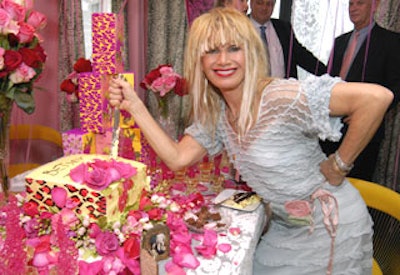 Johnson cut into the leopard print and rose patterned cake that Sylvia Weinstock created for the party.