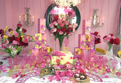 The cake matched the fragrance boxes, which were stacked on a large table dotted with bottles of the scent, rose petals, and the designer’s own decorative objects.