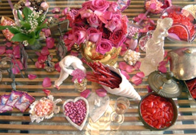 A variety of Johnson’s bric-a-brac served as bowls for candy, amid a scattering of rich pink rose petals.