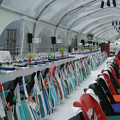 Brightly colored striped beach bags hung from each guest's chair.