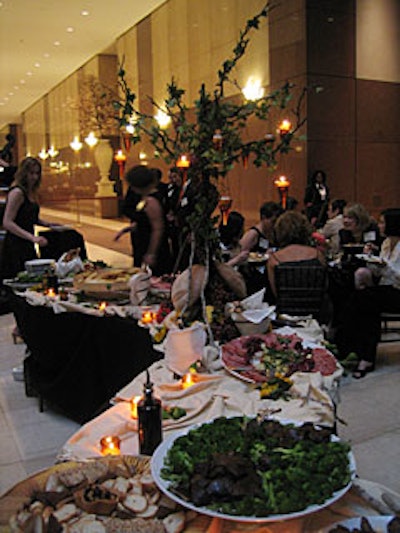 Cer te decorated buffet tables with tea lights suspended from candelabras.