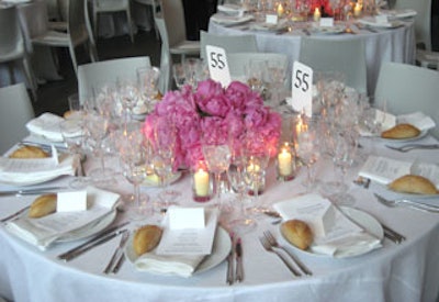 The dining area also had a minimalist look with clean white linens and chairs. Centerpieces of red, pink, and coral-colored peonies added a little color to the room.