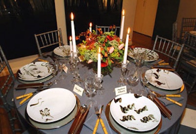 The table settings featured Park Jong-hoon plates on Crate & Barrel silver chargers, with faux bamboo-handled silverware and stainless steel Korean spoons and chopsticks on wooden utensil rests.