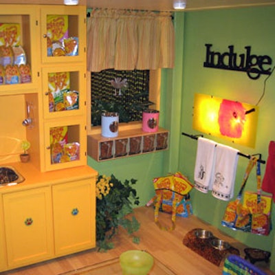 Bright yellow cabinets filled with cat food decorated the Meow Mix House kitchen.