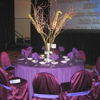 The three- to four-foot tall centerpieces were made with long stemmed pink and white flowers and curly willows sprayed with silver glitter.