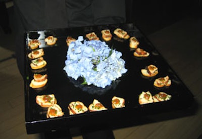 Taste served hors d'oeuvres from black lacquer trays decorated with blue hydrangea.