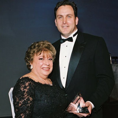 Fedele Miranda, general manager of Peerless Merchants, accepted his award from Gladys Mouton di Stefano, president of the Food and Beverage Association of America.