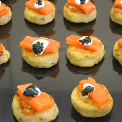Caterwaiters passed smoked salmon on rosti with black caviar and cr?me fra?iche.