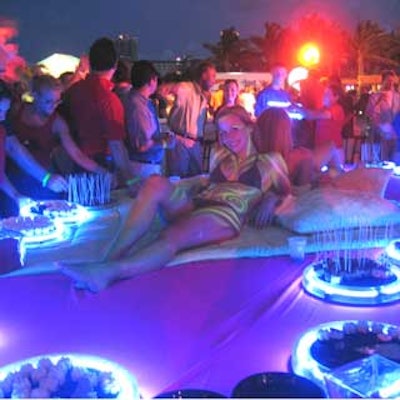 Models lounged on the dessert table, which glowed from the neon-lit trays.