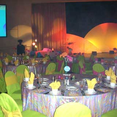 Tables dressed in multicolored psychedelic swirl-pattered linens were paired with lime green chair covers.