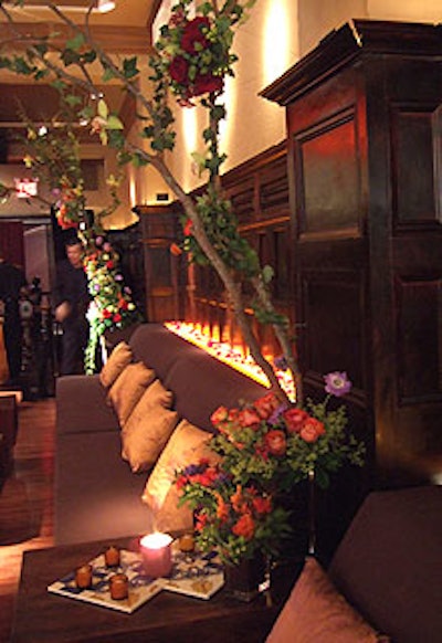 Tall arrangements of branches, wildflowers, and fragrant herbs contrasted with the venue’s dark decor.