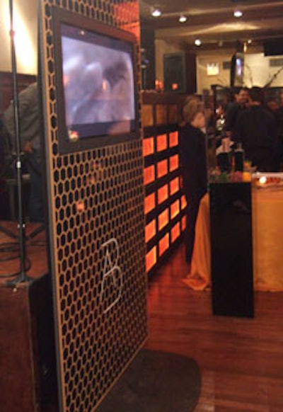The freestanding walls that encased plasma screen televisions (showing a 30-second commercial for the fragrance) mimicked the honeycomb pattern of the box.