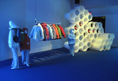 Stacked white cloud screen units accompanied clothing displays.
