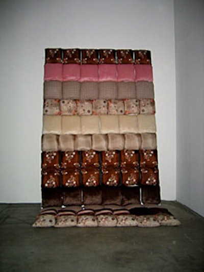 Two silk pillow installations lined the back walls of the space, adding to the modern gallery vibe.
