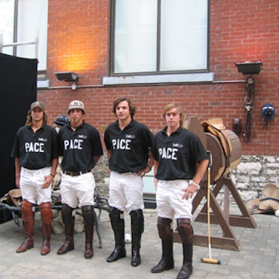 Professional Argentinean polo players posed by a wooden horse at Brassaii for Rethink Breast Cancer's Rock the Preppy fund-raiser.
