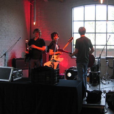 Indie band Uncut performed on a stage with pink up-lights.