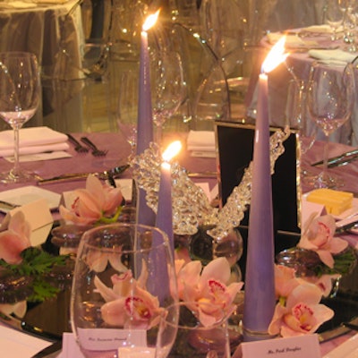 Orchids and purple tapered candles from Fiori Florals accented original glass centerpieces from Tanya Lyons.