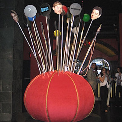 Devin Delano placed two giant red pincushions bearing pins and needles with cast member’s visage in the two salons adjacent to Buddha-Bar’s main room. Suzanne Couture Modelmaking created the cushions, which were a take on the advertisements for Project Runway’s third season.