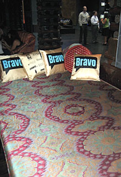 Pillows with the Bravo logo contrasted against Buddha-Bar's Asian print furniture.