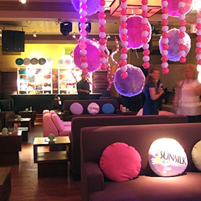 Plastic beads and fuzzy spheres representing different hair types—kinky, poofy, straight, and curly—hung from the ceiling.