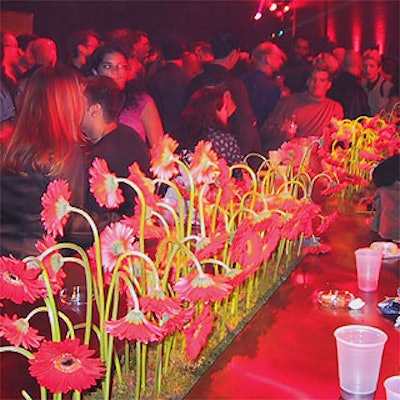 Musters & Company's table with red flowers ran through the center of Hammerstein Ballroom.