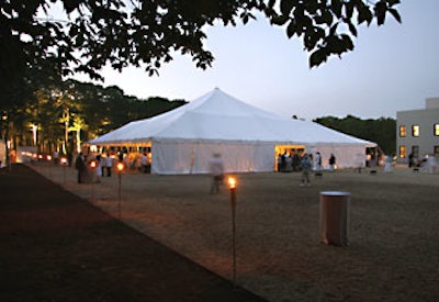 Adjacent to Starr Tents' large dinner tent was a series of lawn torches.