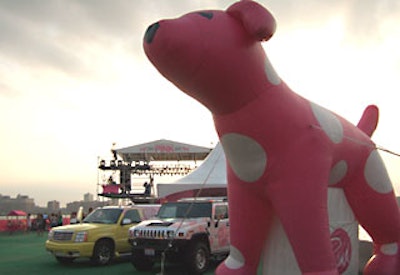 An inflatable version of the Victoria’s Secret Pink dog towered over the two customized Hummers.
