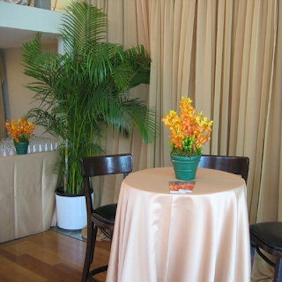 Cream satin linens from The Richmond and potted flower arrangements decorated the breakfast tables.