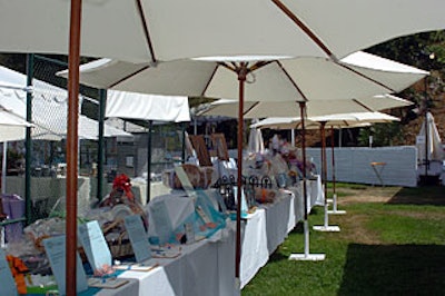 Beige umbrellas over auction tables helped shield guests from the fierce mid-July sun.