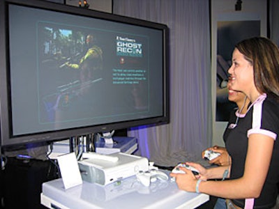 Gamers from the all-female Frag Dolls team demonstrated the wireless gaming equipment and competed against the mostly male audience of media professionals.