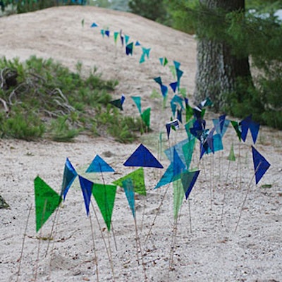To highlight the property's dunes, event designer Eve Suter fabricated 3,000 small flags from lighting gels and scattered them throughout the grounds.