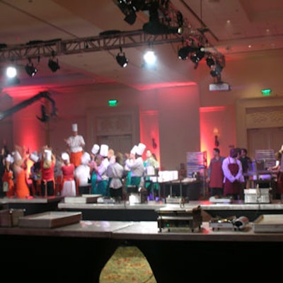 Surprised guests entered a large ballroom set up to resemble the Iron Chef's kitchen stadium, complete with multiple cooking stations for a dozen color-coded teams.