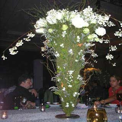 Hand-arranged silk floral arrangements sat atop table runners made of genuine river rocks.