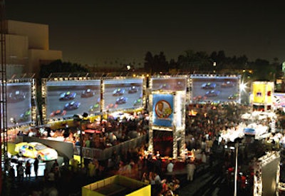 Along one side of the party was a large arc formed by several 20- by 40-foot custom-made screens showing car races.