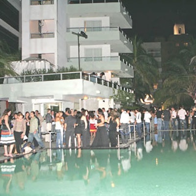Guests mingled poolside before the event-threatening rain began.