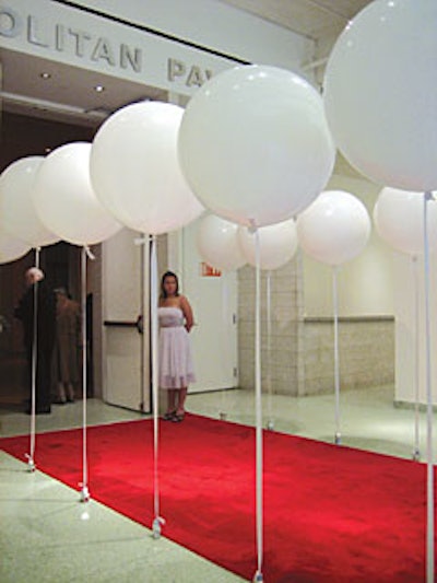 The American Folk Art Museum's Katie Hush and Matt Beaugrand used balloons to add some dimension and texture to the otherwise stark facade of Metropolitan Pavilion, which hosted the museum's benefit. Rows of large, stationary white balloons, attached to rigid ribbons and weighted down by silver stars, lined the red carpet.