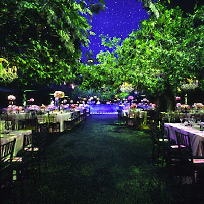 Crystal chandeliers dangled from four 20-foot-tall oak trees with 10,000 silk pin oak sprays constructed by Keith Greco.