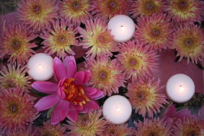 Pink-and-gold dahlias floated with candles in water gardens.