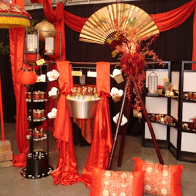 Beyond Details used traditional Asian elements including a wall fan, red silk scarves, embroidered pillows, paper lanterns, and more to create a minimalist environment for Chez Gourmet Catering's food.