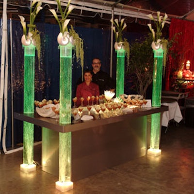 Medallion Occasions' station combined water-filled acrylic poles lit in green and topped with calla lilies.