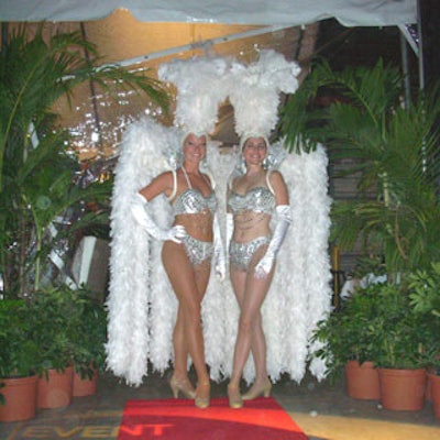 Two models from Sixth Star Entertainment & Marketing dressed in sequin costumes and feathered headdresses greeted guests as they entered the main event.