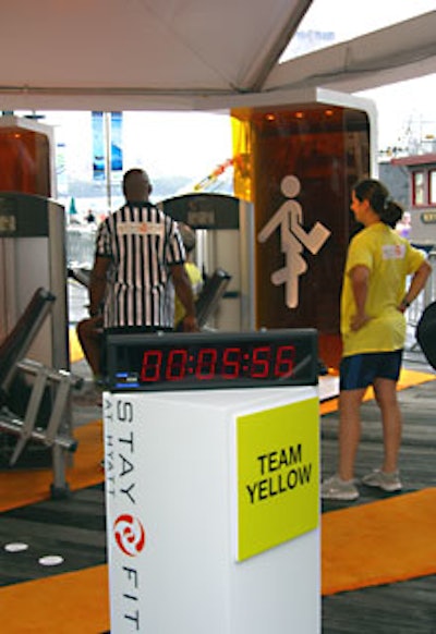 A businesswoman from the yellow team waits for her teammate to complete his task