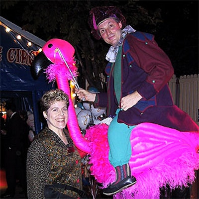 Pamela Miller, the Big Apple Circus' director of special events, posed with a stilt-walking performer at the circus' gala.