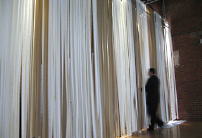 XA constructed a wall entirely out of cream and bronze grosgrain ribbons.