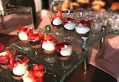 Strawberries topped chocolaty dessert cups.