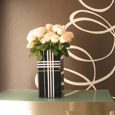 A bouquet of white roses in a black-and-white vase accented the V.I.P. lounge entrance.