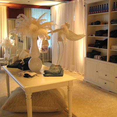 White shelving units contained Diesel sweaters, jeans, and handbags