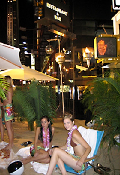 More models lounged about on beach towels and chairs.