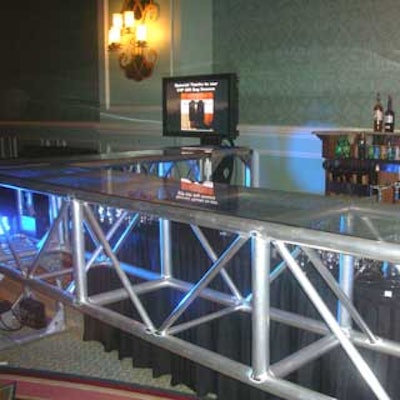 Paradise Show & Design built a bar out of trussing and uplit it in blue.