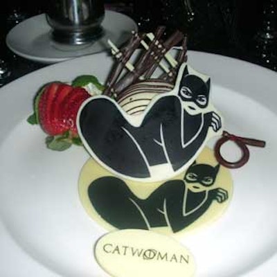 Dessert was a Catwoman made of white chocolate holding a licorice whip adorned with a chocolate sculpture and a strawberry.